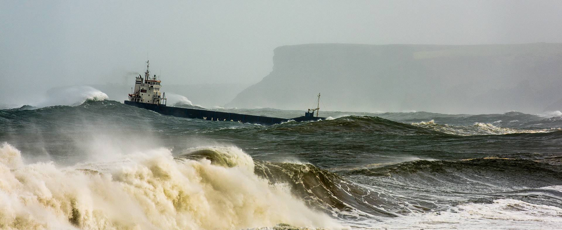 Barco entrando a puerto en pleno temporal en la bahía de Santander en Cantabria.
